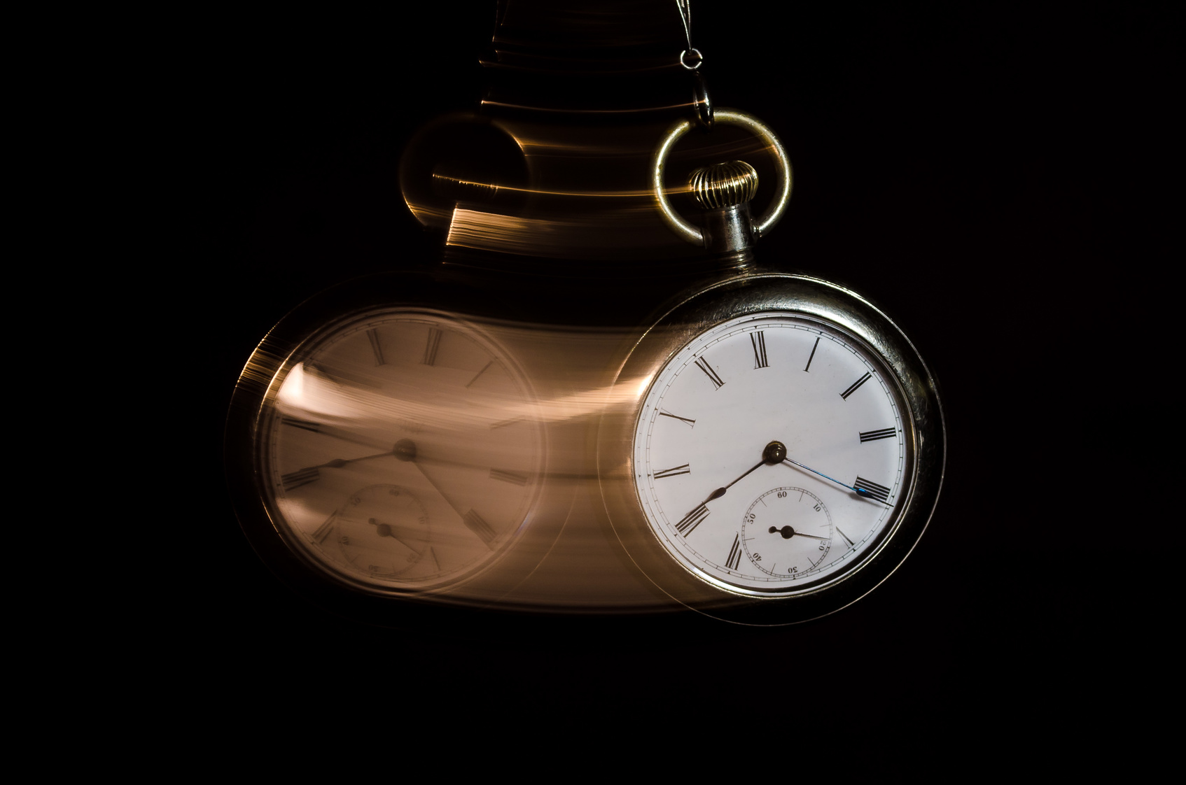 Swinging Pocket Watch Beckoning You to Look More Closely